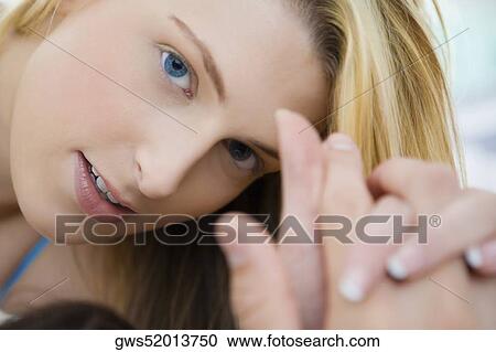 Close-up of a young woman holding a man's hand View Large Photo Image Stock Image - Close-up of a young woman holding a man's hand. Fotosearch