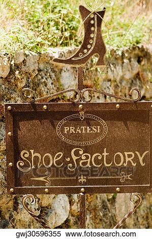 Stock Photography - Close-up of an information sign of a shoe factory, Monteriggioni, Siena Province, Tuscany, Italy. Fotosearch
