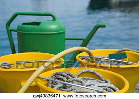 Stock Image - Close-up of buckets with a watering can, Italian Riviera, Santa Margherita Ligure, Genoa, Liguria, Italy. Fotosearch