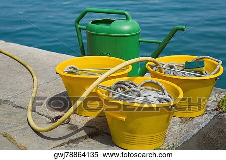 Close-up of buckets with a watering can, Italian Riviera, Santa Margherita Ligure, Genoa, Liguria, Italy View Large Photo Image Stock Photography - Close-up of buckets with a watering can, Italian Riviera, Santa Margherita Ligure, Genoa, Liguria, Italy. Fotosearch