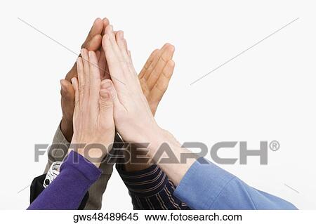 Stock Photography - Close-up of business people's hand giving high-five. Fotosearch