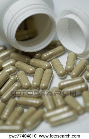 Close-up of capsules spilling out from pill bottles View Large Photo Image Stock Image - Close-up of capsules spilling out from pill bottles. Fotosearch