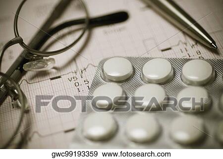 Close-up of eyeglasses with pills on an electrocardiogram report View Large Photo Image Stock Photo - Close-up of eyeglasses with pills on an electrocardiogram report. Fotosearch