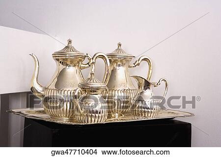 Close-up of silver teapots with sugar bowls in a tray View Large Photo Image Picture - Close-up of silver teapots with sugar bowls in a tray. Fotosearch