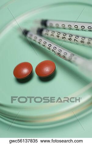 Close-up of three syringes with pills in a petri dish View Large Photo Image Stock Photography - Close-up of three syringes with pills in a petri dish. Fotosearch