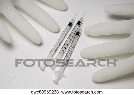 Close-up of three syringes with two gloves View Large Photo Image Stock Photo - Close-up of three syringes with two gloves. Fotosearch