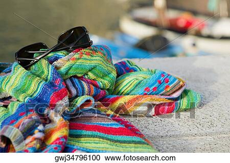 Close-up of towels with a sunglasses, Cinque Terre National Park, Vernazza, La Spezia, Liguria, Italy View Large Photo Image Stock Image - Close-up of towels with a sunglasses, Cinque Terre National Park, Vernazza, La Spezia, Liguria, Italy. Fotosearch