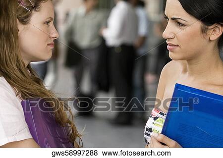 Close-up of two young women looking at each other View Large Photo Image Stock Photo - Close-up of two young women looking at each other. Fotosearch