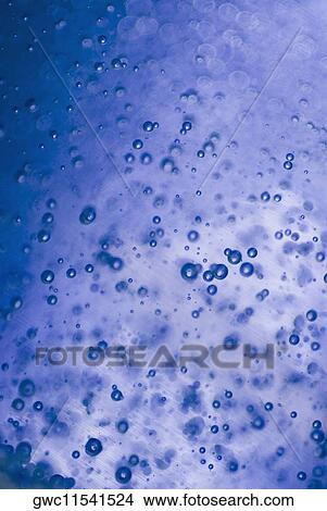 Picture - Close-up of water droplets on a blue background. Fotosearch