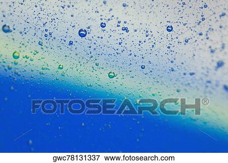 Stock Photo - Close-up of water droplets on a blue background. Fotosearch