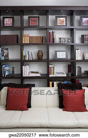 Couch in front of shelves in a living room View Large Photo Image Stock Photo - Couch in front of shelves in a living room. Fotosearch
