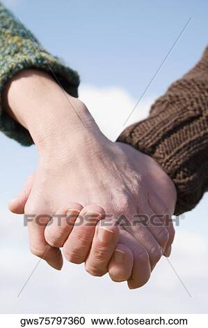 Couple holding each other's hands View Large Photo Image Stock Image - Couple holding each other's hands. Fotosearch