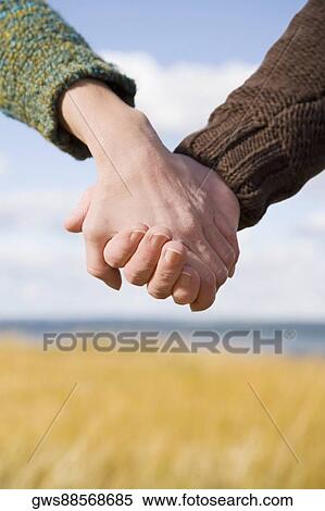 Couple holding each other's hands View Large Photo Image Stock Photography - Couple holding each other's hands. Fotosearch