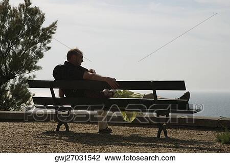 Couple on a bench, Biarritz, Basque Country, Pyrenees-Atlantiques, Aquitaine, France View Large Photo Image Stock Image - Couple on a bench, Biarritz, Basque Country, Pyrenees-Atlantiques, Aquitaine, France. Fotosearch