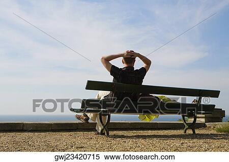 Couple resting on a bench, St. Martin, Biarritz, France View Large Photo Image Stock Photography - Couple resting on a bench, St. Martin, Biarritz, France. Fotosearch