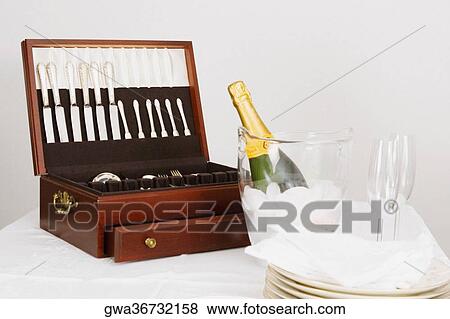Cutlery box with a champagne bottle and tableware on a dining table View Large Photo Image Stock Photo - Cutlery box with a champagne bottle and tableware on a dining table. Fotosearch