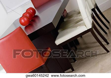 Stock Image - Decorative urns on a dining table in a dining room. Fotosearch
