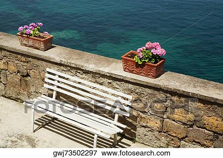 Empty bench and potted plants at seaside, Bay of Naples, Sorrento, Sorrentine Peninsula, Naples Province, Campania, Italy View Large Photo Image Stock Photo - Empty bench and potted plants at seaside, Bay of Naples, Sorrento, Sorrentine Peninsula, Naples Province, Campania, Italy. Fotosearch