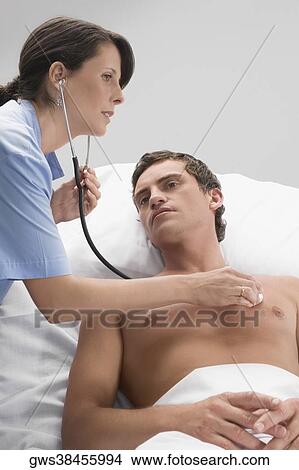 Female doctor examining a patient View Large Photo Image Picture - Female doctor examining a patient. Fotosearch
