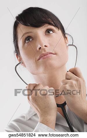 Picture - Female doctor holding a stethoscope. Fotosearch