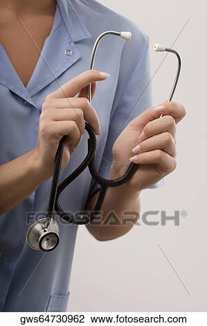 Female doctor holding a stethoscope View Large Photo Image Stock Image - Female doctor holding a stethoscope. Fotosearch