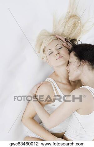 Female homosexual couple embracing each other on the bed View Large Photo Image Stock Image - Female homosexual couple embracing each other on the bed. Fotosearch