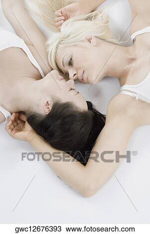 Female homosexual couple lying on the bed View Large Photo Image Stock Image - Female homosexual couple lying on the bed. Fotosearch