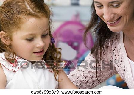 Female teacher teaching her student in a classroom View Large Photo Image Stock Photo - Female teacher teaching her student in a classroom. Fotosearch