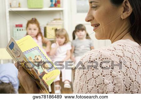 Stock Photo - Female teacher teaching her students in a classroom. Fotosearch