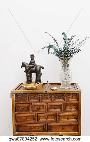 Figurine and a vase on a chest View Large Photo Image Stock Image - Figurine and a vase on a chest. Fotosearch