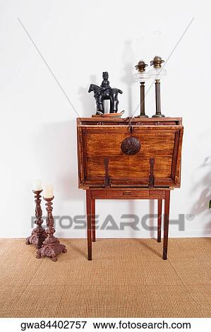 Stock Photo - Figurine and lanterns on a chest with candlestick holders. Fotosearch