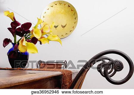 Flowers in a vase on a dining table View Large Photo Image Stock Photograph - Flowers in a vase on a dining table. Fotosearch