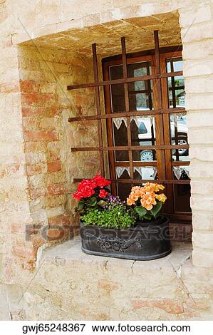 Flowers in a window box on a window sill, Monteriggioni, Siena Province, Tuscany, Italy View Large Photo Image Stock Photo - Flowers in a window box on a window sill, Monteriggioni, Siena Province, Tuscany, Italy. Fotosearch