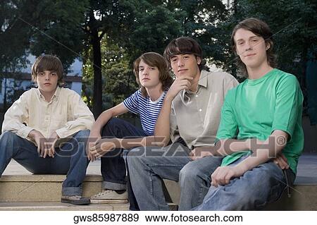 Four friends sitting together View Large Photo Image Stock Photo - Four friends sitting together. Fotosearch