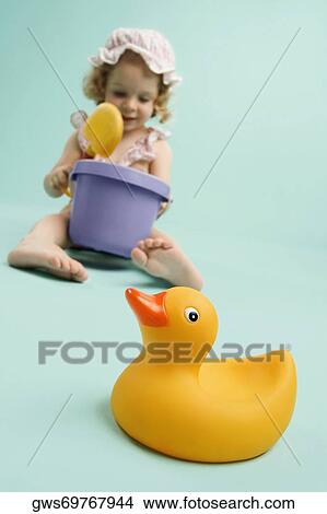 Girl playing with toys and smiling View Large Photo Image Picture - Girl playing with toys and smiling. Fotosearch