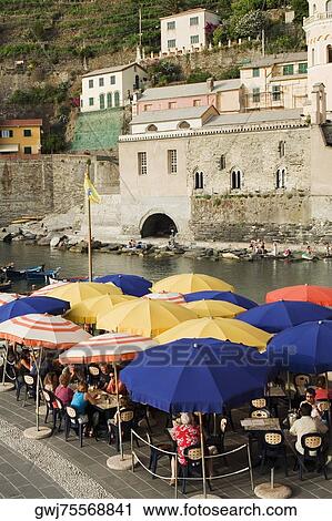 Group of people at a sidewalk cafe, Italian Riviera, Cinque Terre National Park, Il Porticciolo, Vernazza, La Spezia, Liguria, Italy View Large Photo Image Stock Image - Group of people at a sidewalk cafe, Italian Riviera, Cinque Terre National Park, Il Porticciolo, Vernazza, La Spezia, Liguria, Italy. Fotosearch