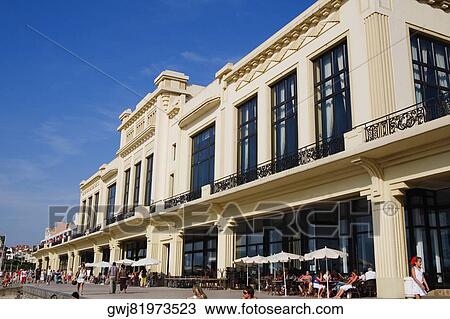 Stock Image - Group of people in front of a hotel, Casino Municipal, Grande Plage, Biarritz, France. Fotosearch
