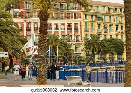 Group of people walking in front of a hotel, Quai Des Etats- Unis, Nice, Provence-Alpes-Cote D'Azur, France View Large Photo Image Stock Image - Group of people walking in front of a hotel, Quai Des Etats- Unis, Nice, Provence-Alpes-Cote D'Azur, France. Fotosearch