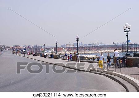 Group of people walking on a sidewalk, Via Partenope, Naples, Naples Province, Campania, Italy View Large Photo Image Picture - Group of people walking on a sidewalk, Via Partenope, Naples, Naples Province, Campania, Italy. Fotosearch