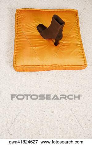 Stock Photo - High angle view of a boot on a cushion. Fotosearch