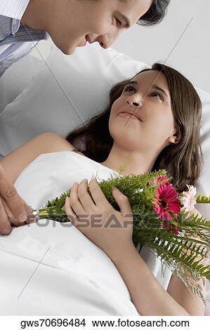 High angle view of a mid adult man looking at a female patient View Large Photo Image Picture - High angle view of a mid adult man looking at a female patient. Fotosearch