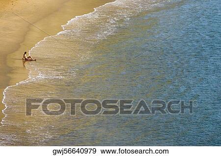 High angle view of a person sitting on the beach, Plage du Miramar, Biarritz, France View Large Photo Image Stock Photo - High angle view of a person sitting on the beach, Plage du Miramar, Biarritz, France. Fotosearch