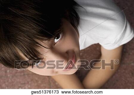 Stock Image - High angle view of a schoolboy smiling. Fotosearch
