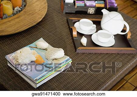 Stock Image - High angle view of a serving tray and magazines on a table. Fotosearch
