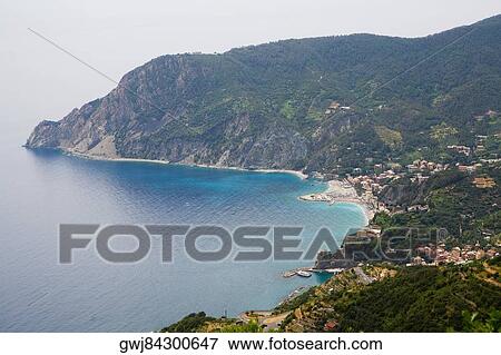 High angle view of a town at the sea side, Ligurian Sea, Italian Riviera, Monterosso al Mare, Cinque Terre, La Spezia, Liguria, Italy View Large Photo Image Stock Photo - High angle view of a town at the sea side, Ligurian Sea, Italian Riviera, Monterosso al Mare, Cinque Terre, La Spezia, Liguria, Italy. Fotosearch