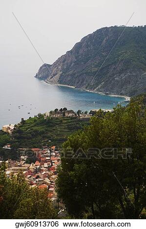 High angle view of a town at the sea side, Ligurian Sea, Italian Riviera, Monterosso al Mare, Cinque Terre, La Spezia, Liguria, Italy View Large Photo Image Stock Photograph - High angle view of a town at the sea side, Ligurian Sea, Italian Riviera, Monterosso al Mare, Cinque Terre, La Spezia, Liguria, Italy. Fotosearch