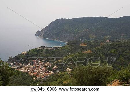 High angle view of a town at the sea side, Ligurian Sea, Italian Riviera, Monterosso al Mare, Cinque Terre, La Spezia, Liguria, Italy View Large Photo Image Stock Photograph - High angle view of a town at the sea side, Ligurian Sea, Italian Riviera, Monterosso al Mare, Cinque Terre, La Spezia, Liguria, Italy. Fotosearch