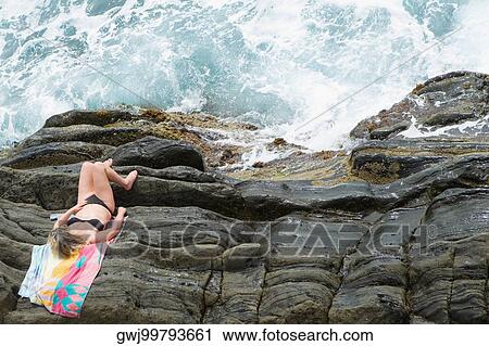 High angle view of a woman lying on cliff, RioMaggiore, Cinque Terre, Italian Riviera, Cinque Terre National Park, Vernazza, La Spezia, Liguria, Italy View Large Photo Image Stock Image - High angle view of a woman lying on cliff, RioMaggiore, Cinque Terre, Italian Riviera, Cinque Terre National Park, Vernazza, La Spezia, Liguria, Italy. Fotosearch