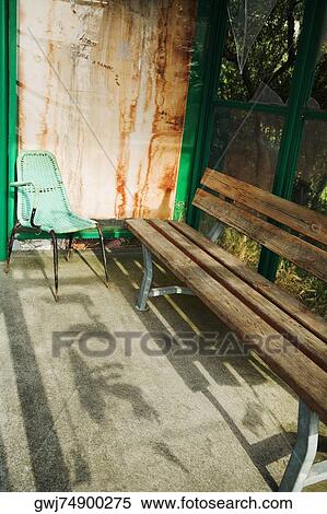 Stock Photography - High angle view of an empty bench with a chair, La Spezia, Liguria, Italy. Fotosearch