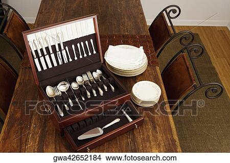 High angle view of an open cutlery box with stacks of plates on a dining table View Large Photo Image Picture - High angle view of an open cutlery box with stacks of plates on a dining table. Fotosearch